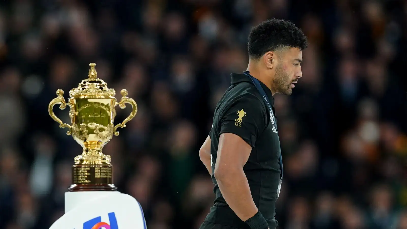 All Blacks flyhalf Richie Mo'unga walks past the Webb Ellis Cup following New Zealand's defeat to South Africa in the Rugby World Cup 2023 final match at the Stade de France in Paris, France