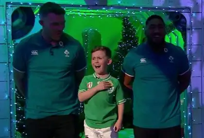 Bundee Aki and Peter O'Mahony with a young fan singing Ireland's Call.