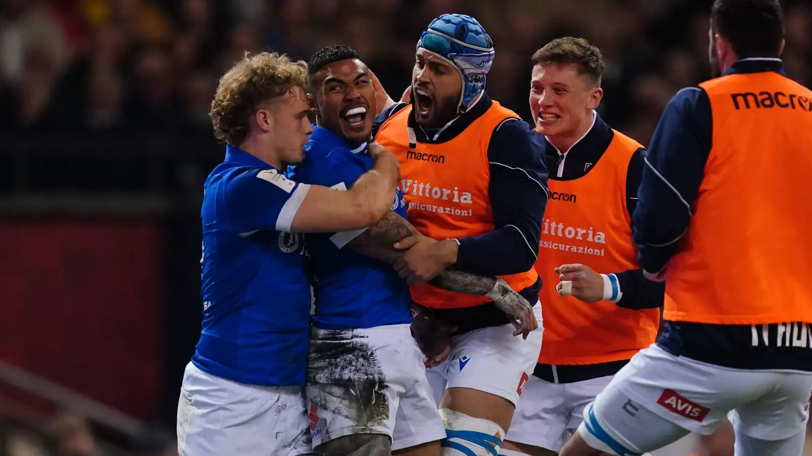 Italy wing Monty Ioane congratulated by teammates.