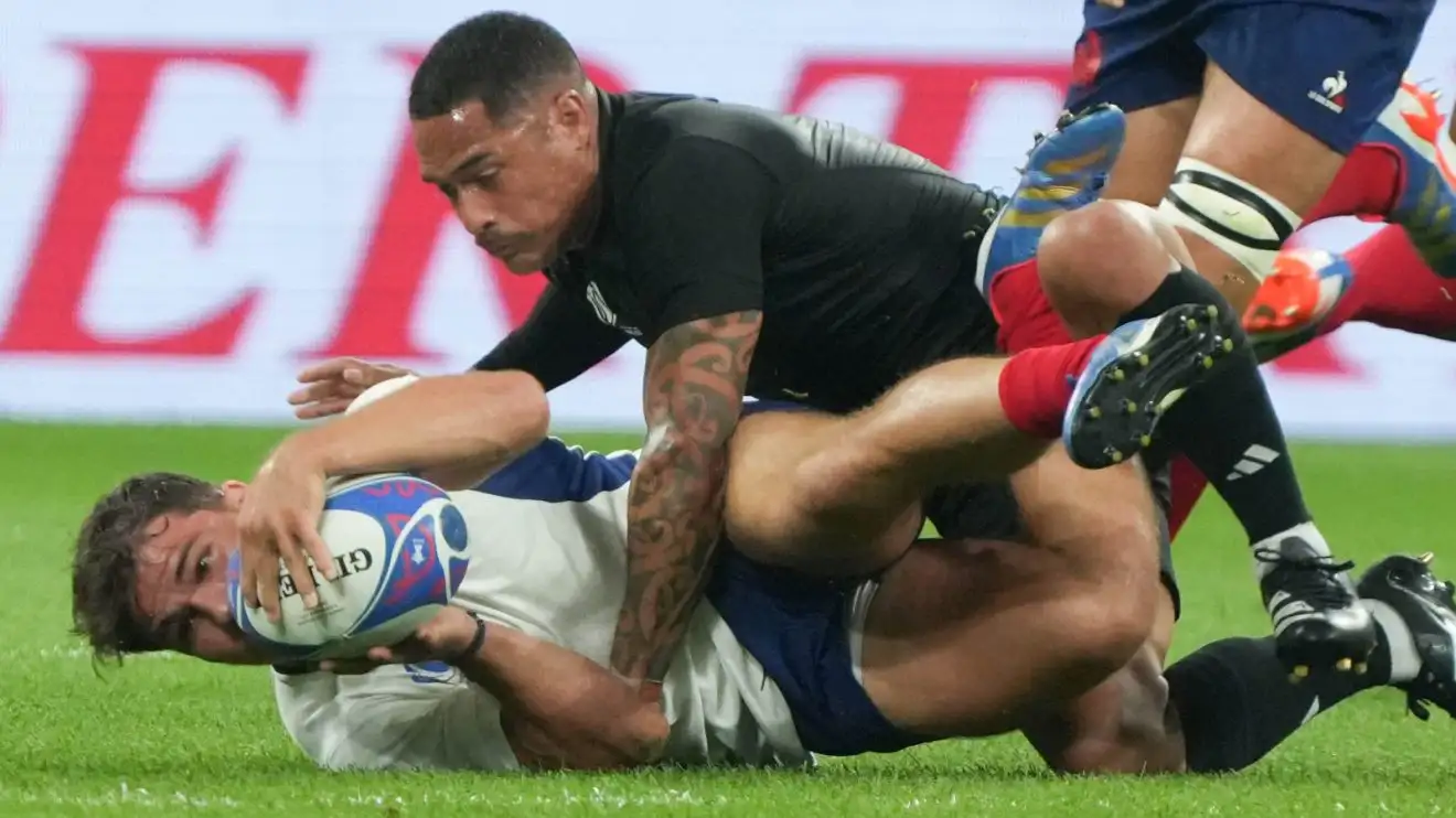 Aaron Smith tackling Antoine Dupont during the 2023 Rugby World Cup.