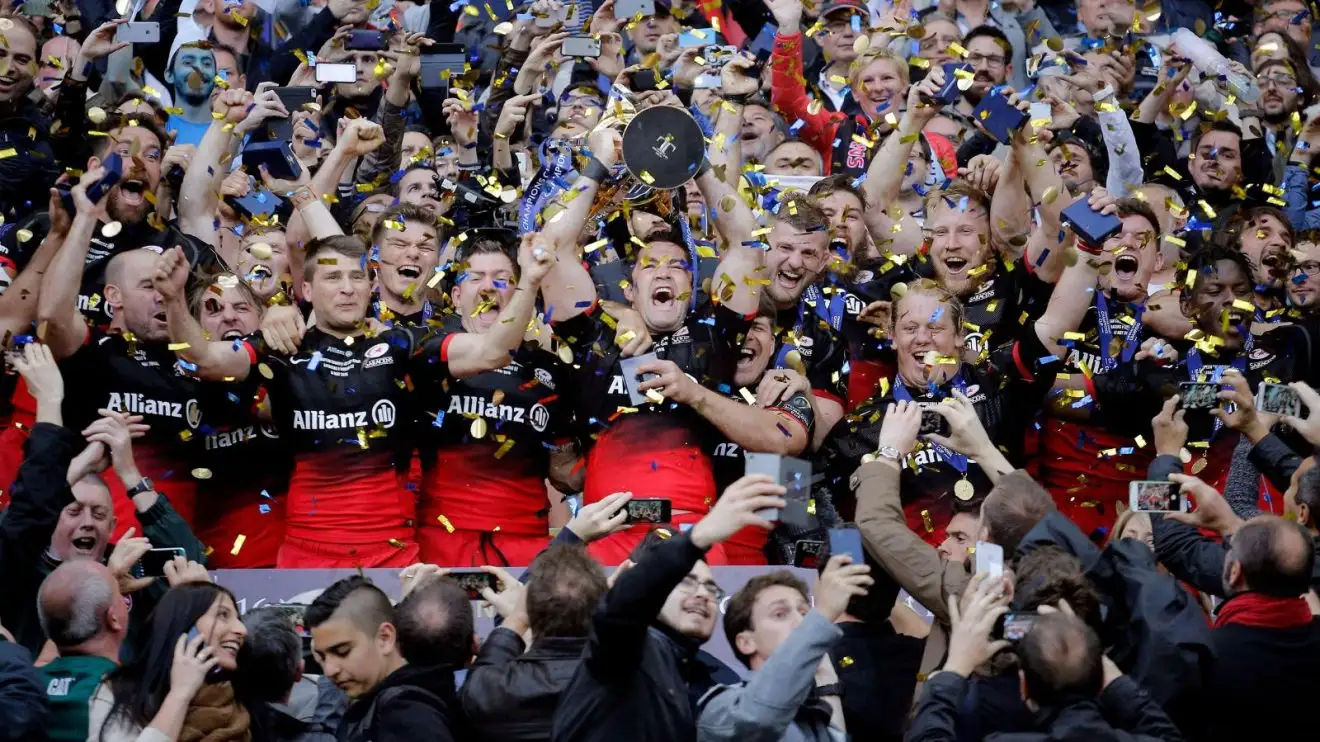 Saracens' players celebrate with their trophy after winning their European Rugby Champions Cup final match against Racing 92