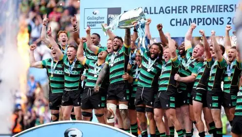 Northampton Saints players celebrate on the pitch with the trophy after winning the Gallagher Premiership final at Twickenham Stadium, London.