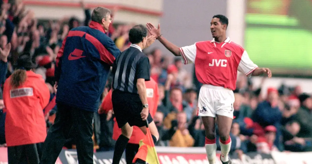 Arsenal's Nicolas Anelka celebrates with Arsene Wenger after scoring against Manchester United.