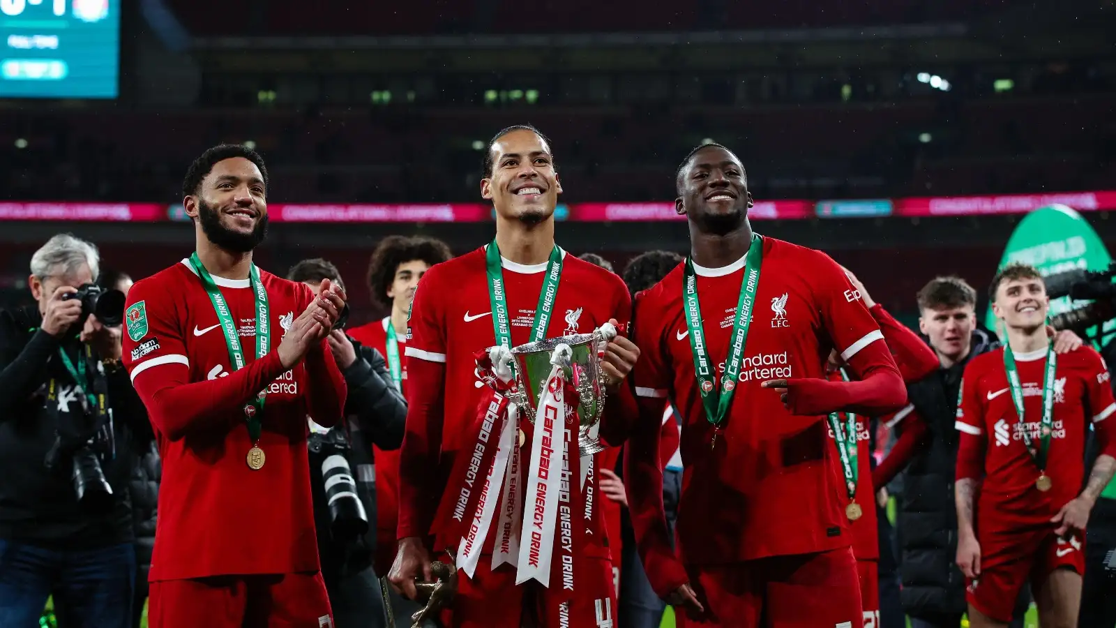 LONDON, UK - 25th Feb 2024: Virgil van Dijk of Liverpool celebrates with the trophy and team mates Joe Gomez and Ibrahima Konate after the EFL Carabao Cup Final match between Chelsea FC and Liverpool FC at Wembley Stadium