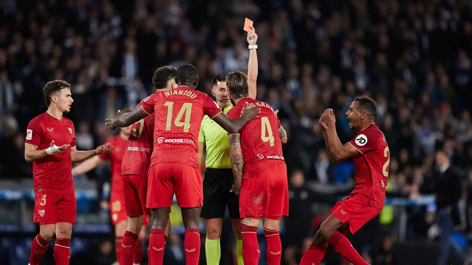 Miguel Angel Ortiz Arias shows a red card to Sergio Ramos of Sevilla FC during the LaLiga EA Sports match between Real Sociedad and Sevilla FC at Reale Arena on November 26, 2023, in San Sebastian, Spain.