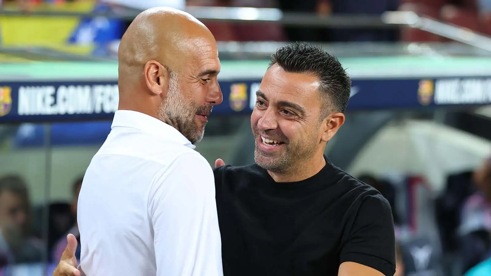 Pep Guardiola and Xavi embrace