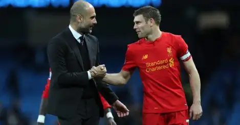 Manchester City manager Pep Guardiola speaks to Liverpool's James Milner at the final whistle of the Premier League match at the Etihad Stadium, Manchester.