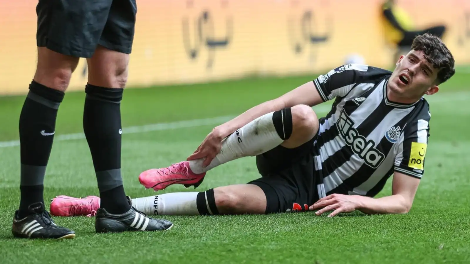 Tino Livramento of Newcastle United lays injured before being substituted during the Premier League match Newcastle United vs West Ham United at St. James's Park, Newcastle, United Kingdom, 30th March 2024