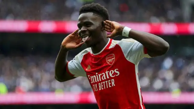 Bukayo Saka celebrates scoring Arsenal's second goal against Tottenham in April 2024.