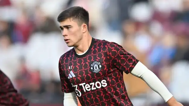 Harry Amass warms up with Manchester United's first team.