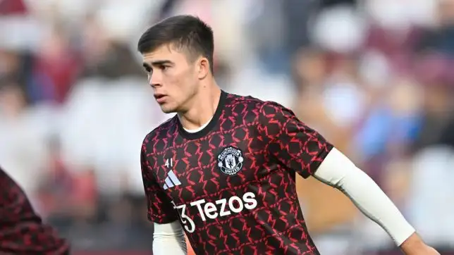 Harry Amass warms up with Manchester United's first team.