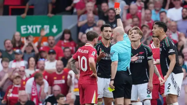 Referee Anthony Taylor shows a red card to Arsenal's Mikel Merino, center, during the English Premier League soccer match between Liverpool and Arsenal, at Anfield stadium in Liverpool, England, Sunday, May 11, 2025.