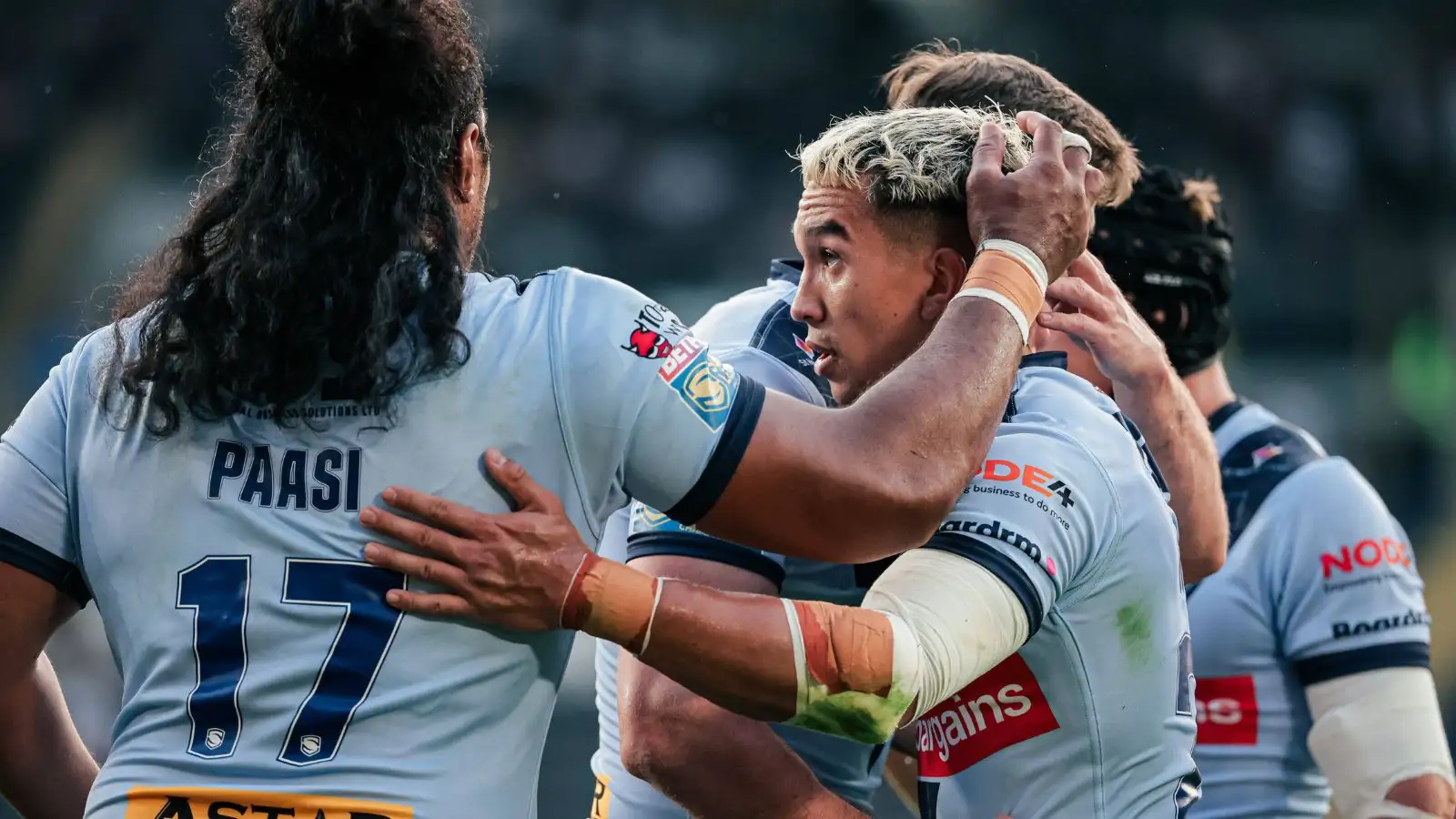 Tee Ritson is congratulated by Agnatius Paasi and Jack Welsby after a try-saving tackle.