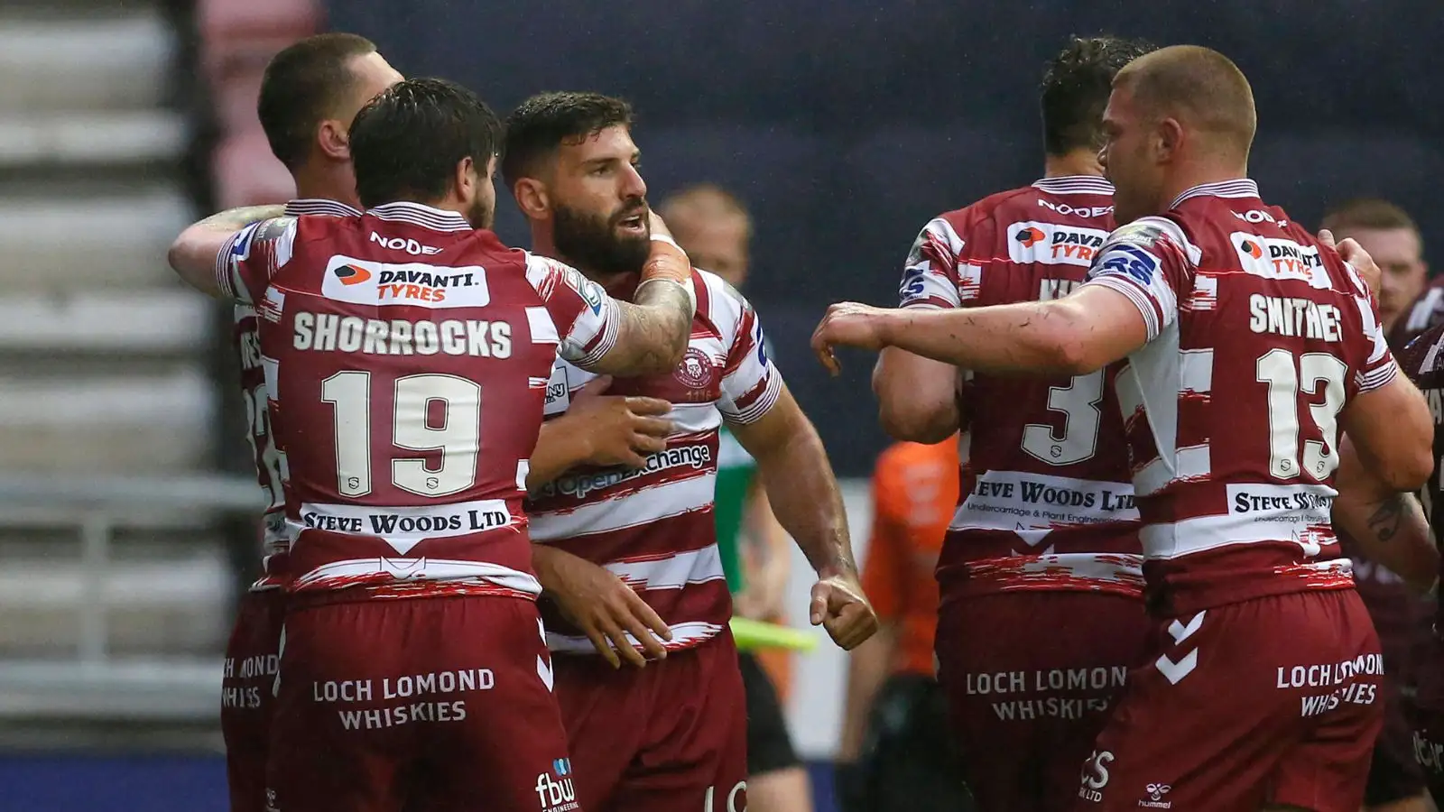 Abbas Miski celebrates with Wigan team-mates after scoring his first against Huddersfield.