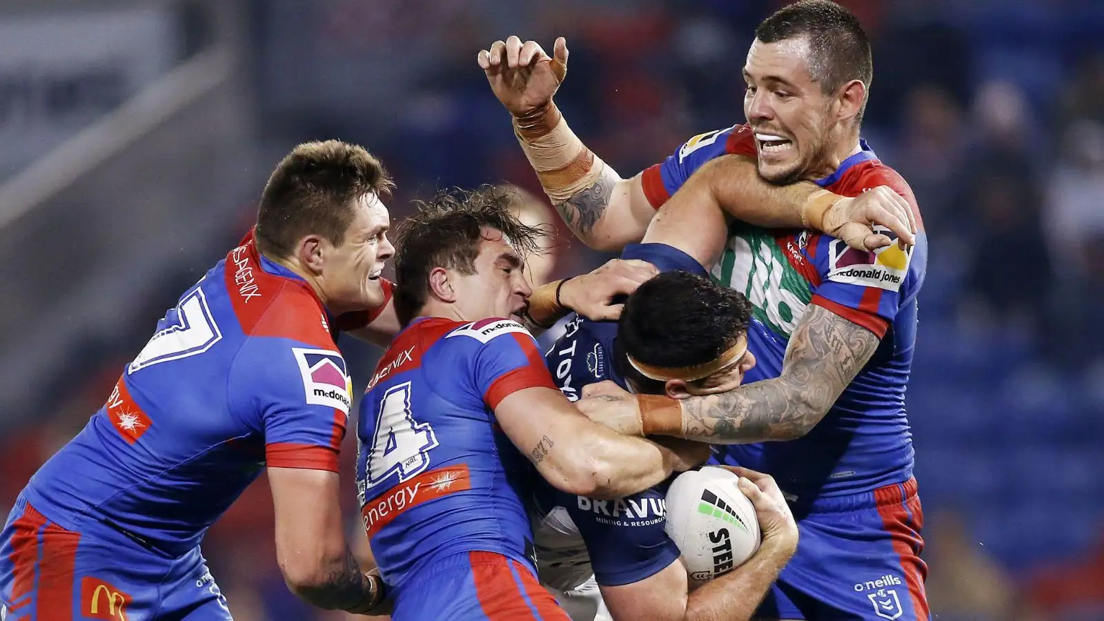 Connor Watson in action for Newcastle Knights in 2021 alongside then-team-mates Brodie Jones and David Klemmer. Photo by AAP Image/Darren Pateman.