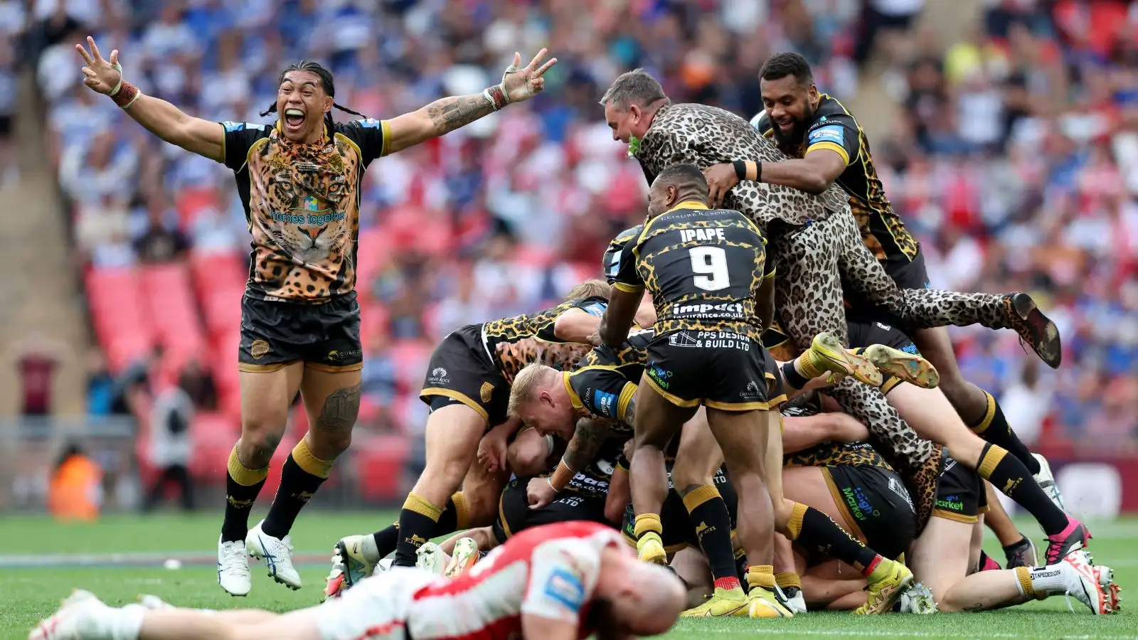 Derek Beaumont celebrates with Leigh Leopards' players on the pitch at Wembley