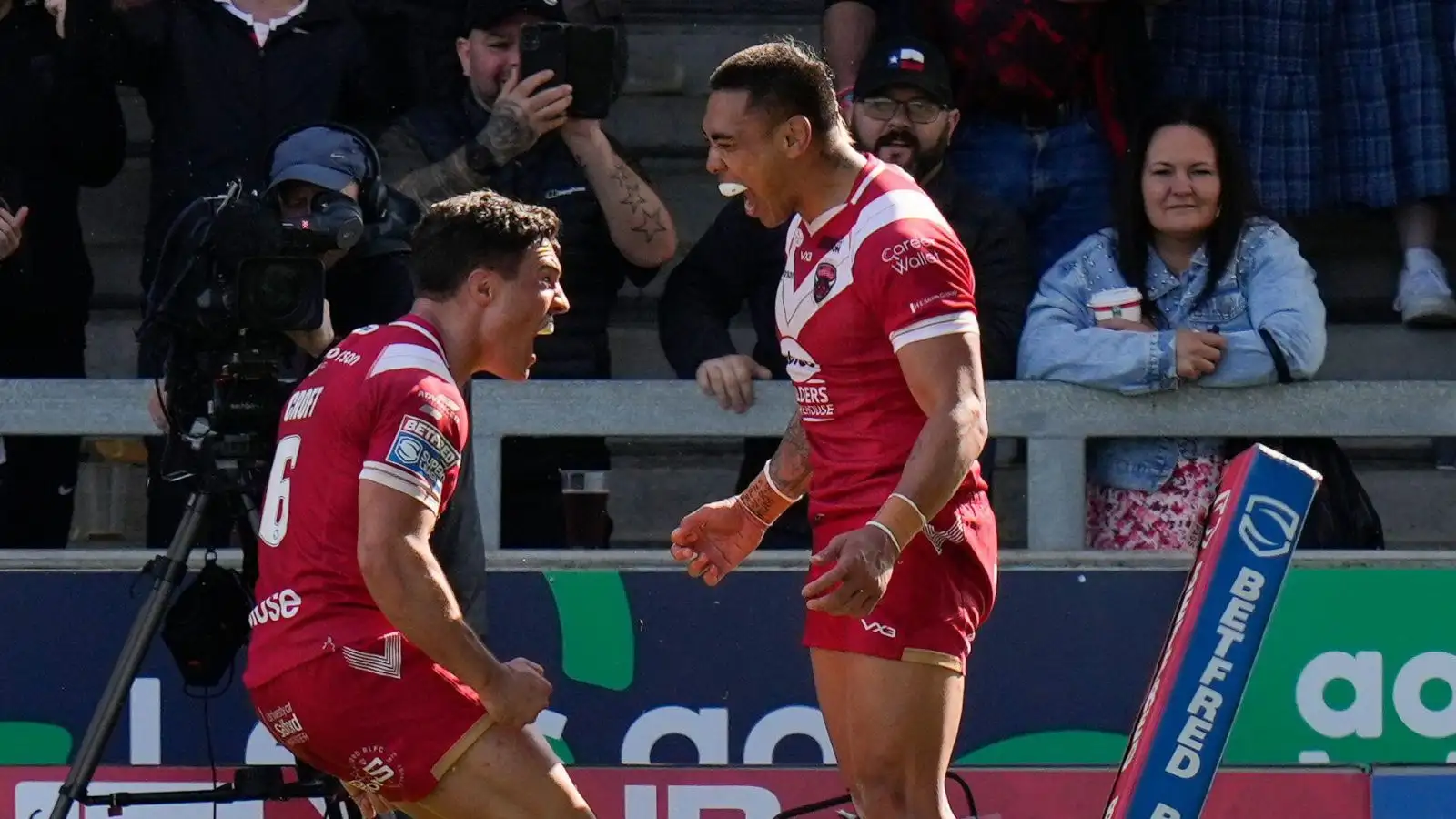 Ken Sio celebrates with Brodie Croft.