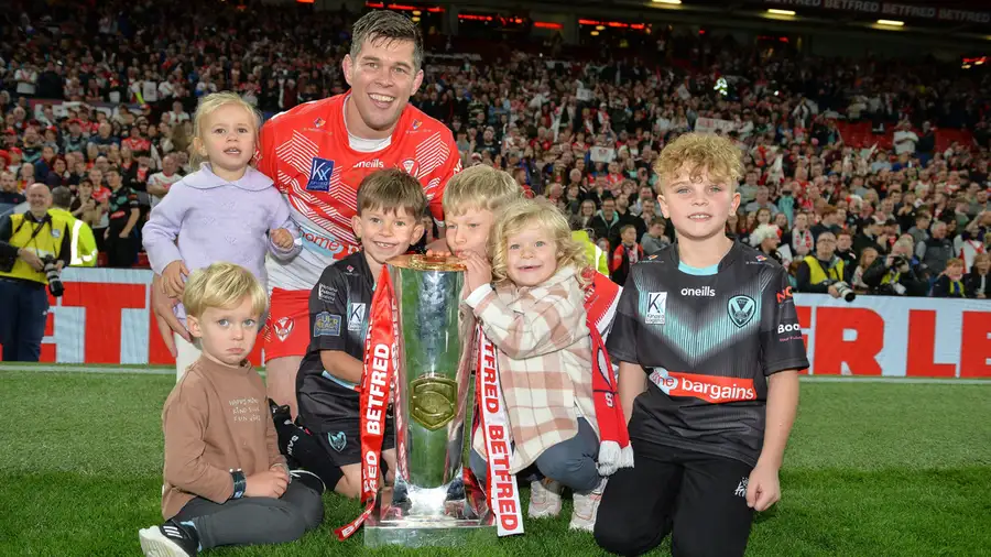 Louie McCarthy-Scarsbrook with his family after St Helens' 2022 Grand Final win at Old Trafford - Alamy