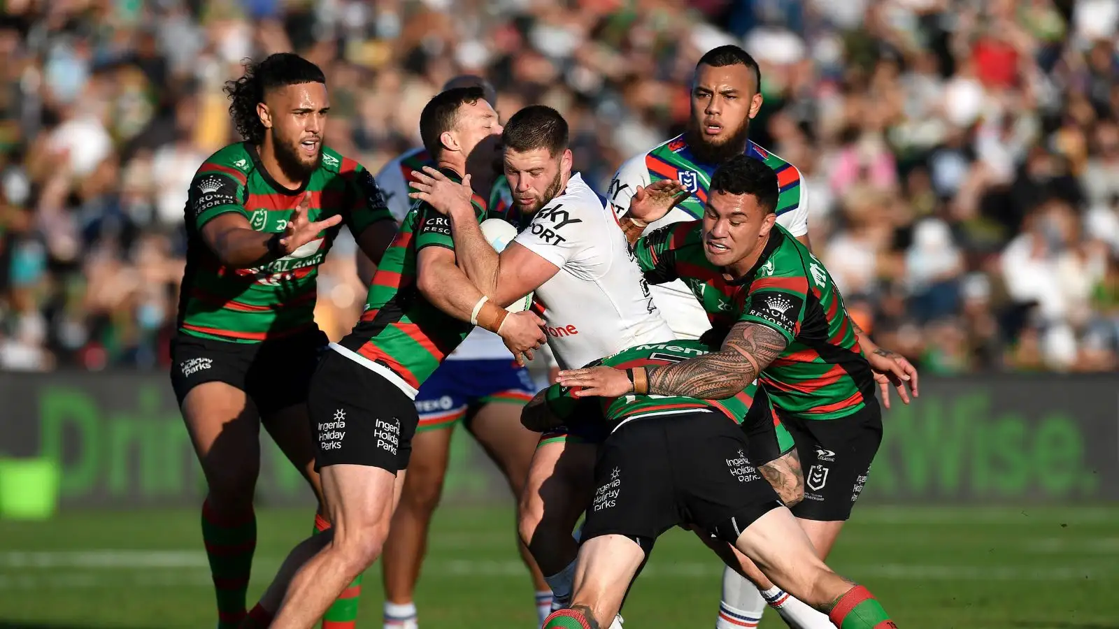 Bayley Sironen tackled by South Sydney Rabbitohs players
