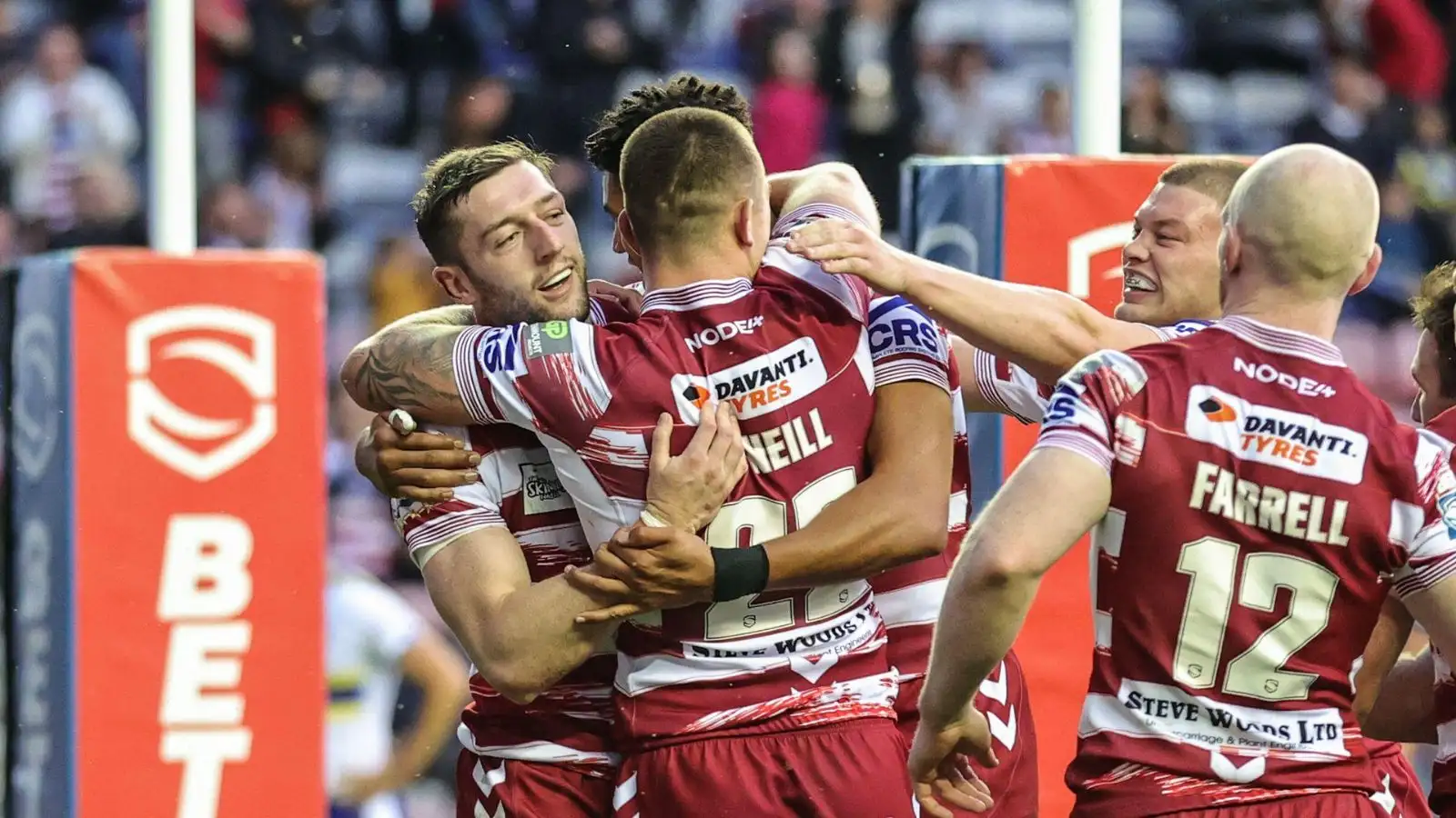 Jake Wardle celebrates with Wigan team-mates after scoring against Warrington in Round 19.