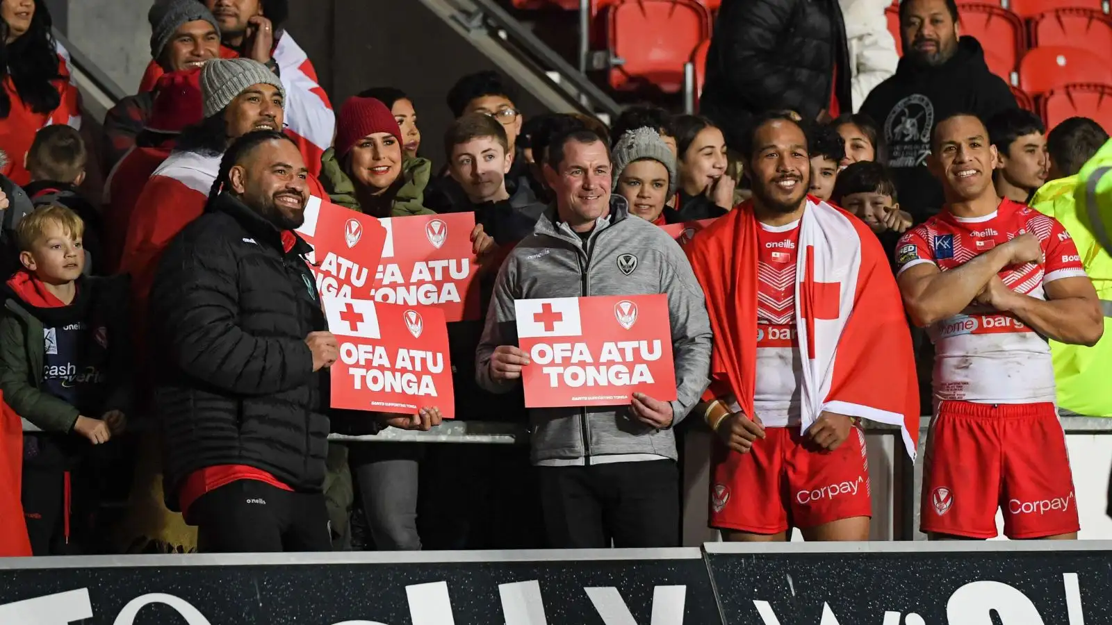 Konrad Hurrell, Kristian Woolf, Agnatius Paasi & Will Hopoate join the St Helens crowd in displaying messages of support for Tonga