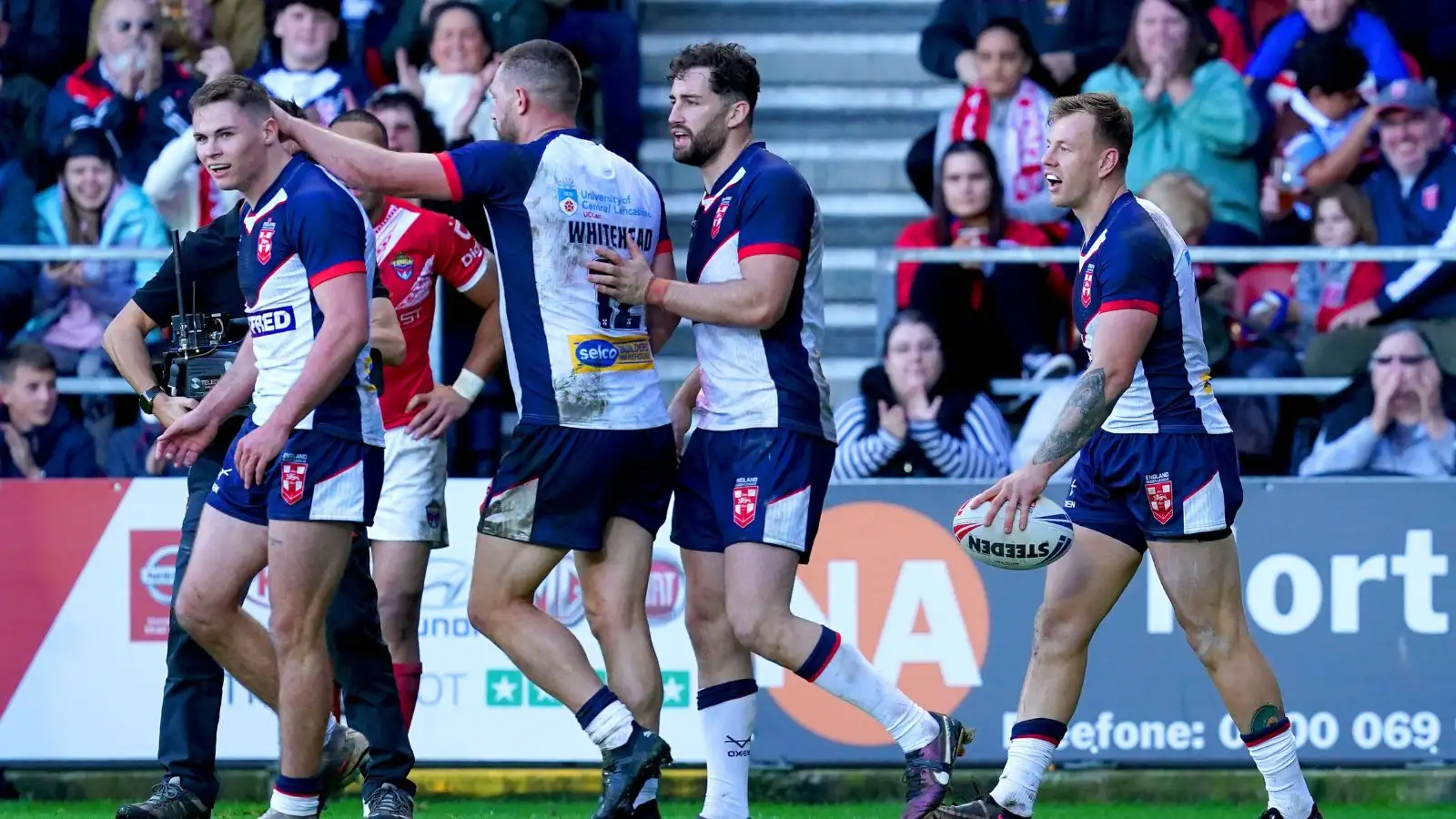 England celebrate a try against Tonga