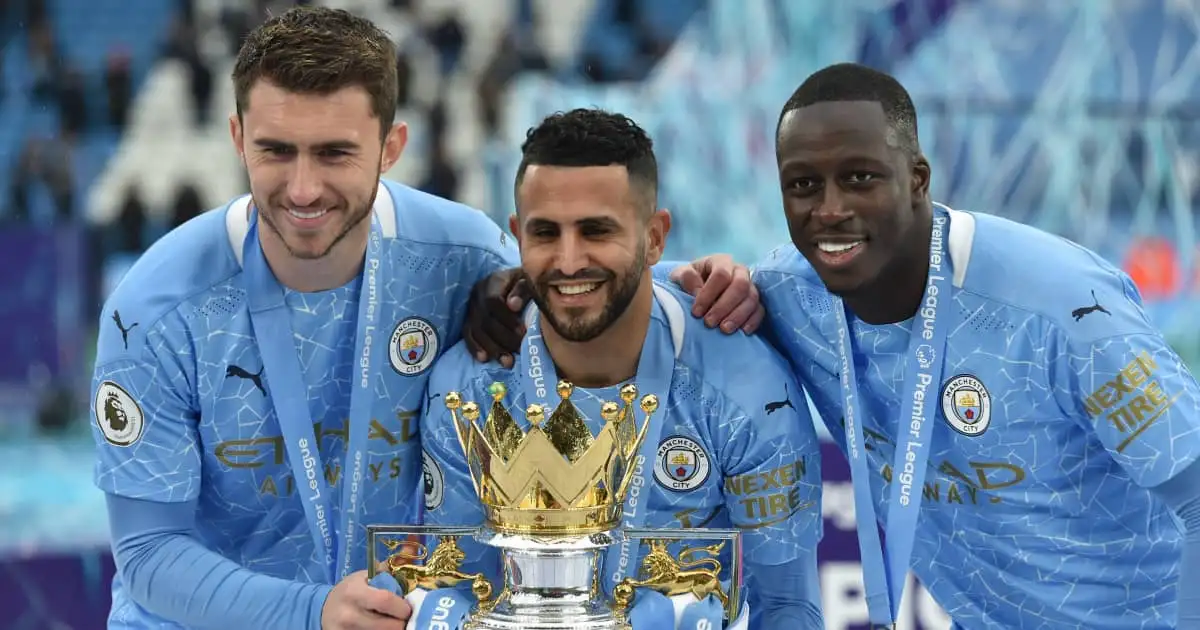 Man City trio Aymeric Laporte Riyad Mahrez and Benjamin Mendy holding the Premier League trophy 2021