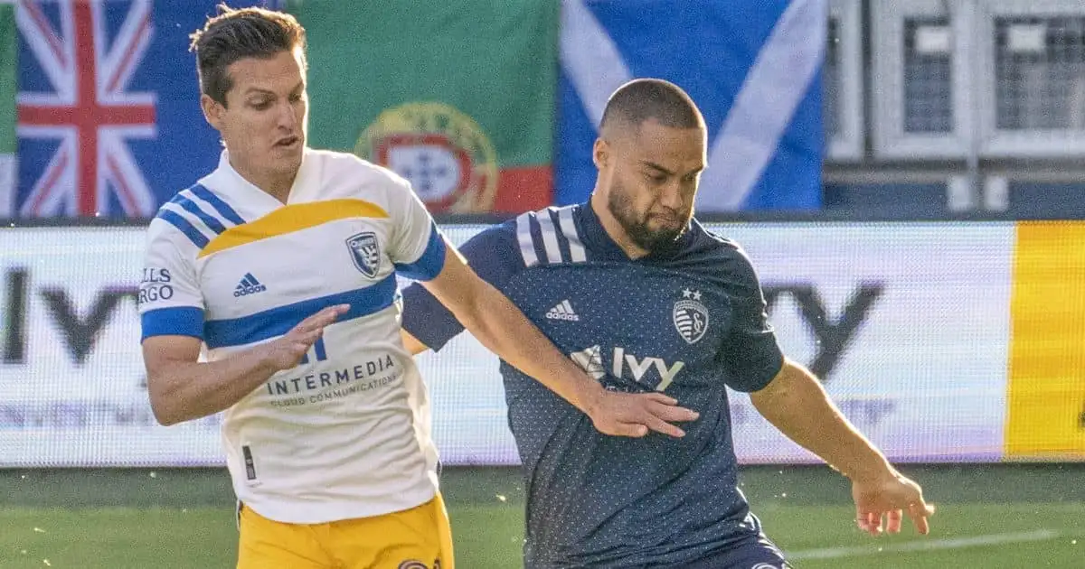 Sporting Kansas City defender Winston Reid (22) moves the ball as San Jose Earthquakes midfielder Carlos Fierro (21) defends during the first half at Children's Mercy Park. Mandatory