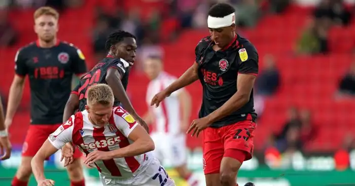 Stoke City's Sam Surridge is tackled by Fleetwood Towns Jay Matete and James Hill during the Carabao Cup first round match