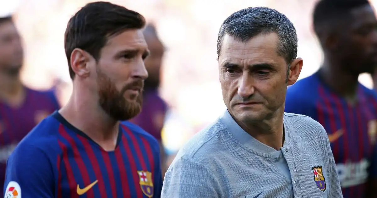 Lionel Messi stands alongside Ernesto Valverde during a Barcelona presentation, 2018