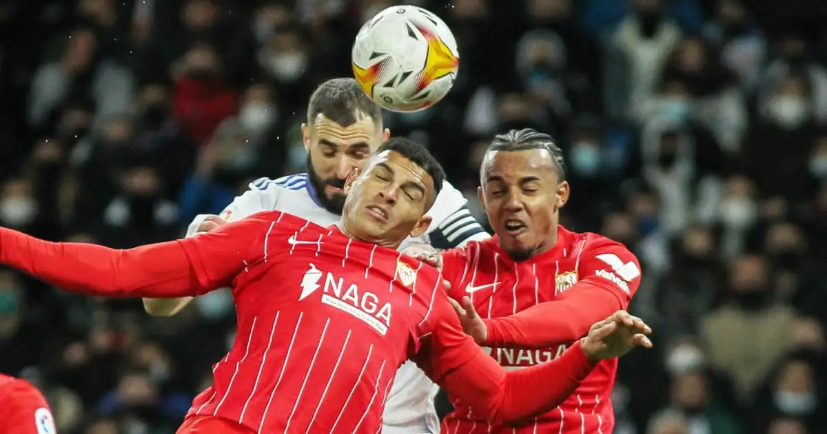 Sevilla defenders Diego Carlos and Jules Kounde battling Real Madrid striker Karim Benzema in the air