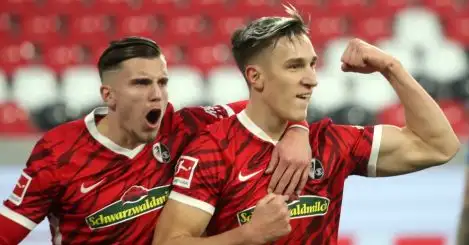Ermedin Demirovic celebrates with goalscorer Nico Schlotterbeck for Freiburg against Hoffenheim