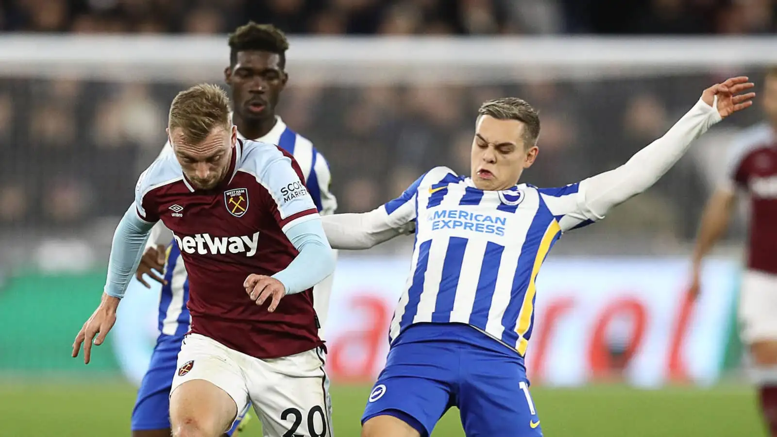 West Ham attacker Jarrod Bowen tussling with Brighton forward Leandro Trossard