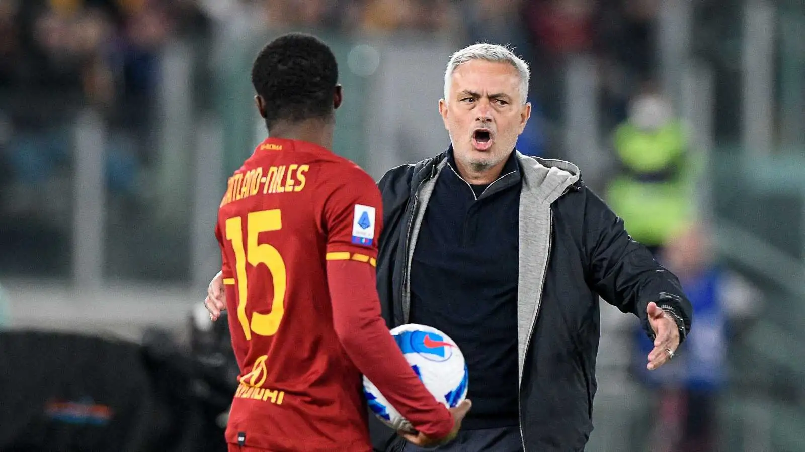 Ainsley Maitland-Niles holding the ball next to Jose Mourinho