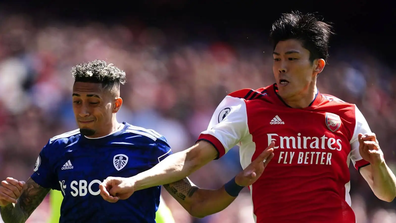 Raphinha of Leeds United and Arsenal's Takehiro Tomiyasu battle for the ball during the Premier League match at the Emirates Stadium, London