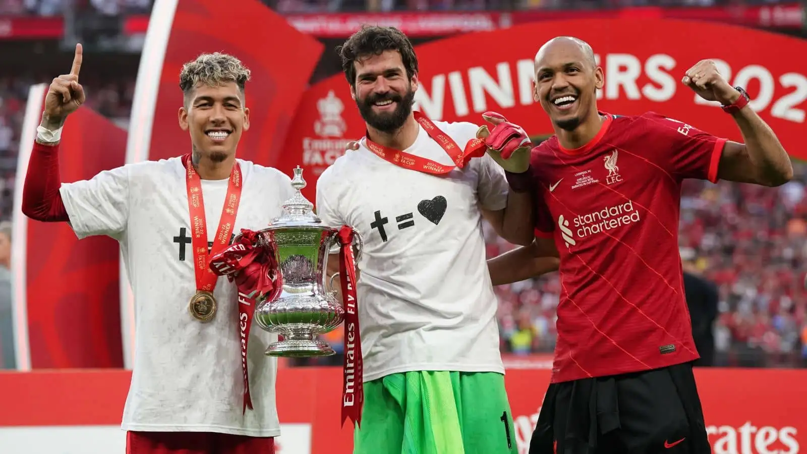 Roberto Firmino (left), goalkeeper Alisson (centre) and Fabinho of Liverpool FC pose with the trophy after the Emirates FA Cup final at Wembley Stadium