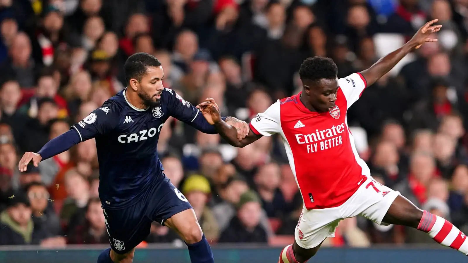 Aston Villa midfielder Douglas Luiz battling Arsenal forward Bukayo Saka