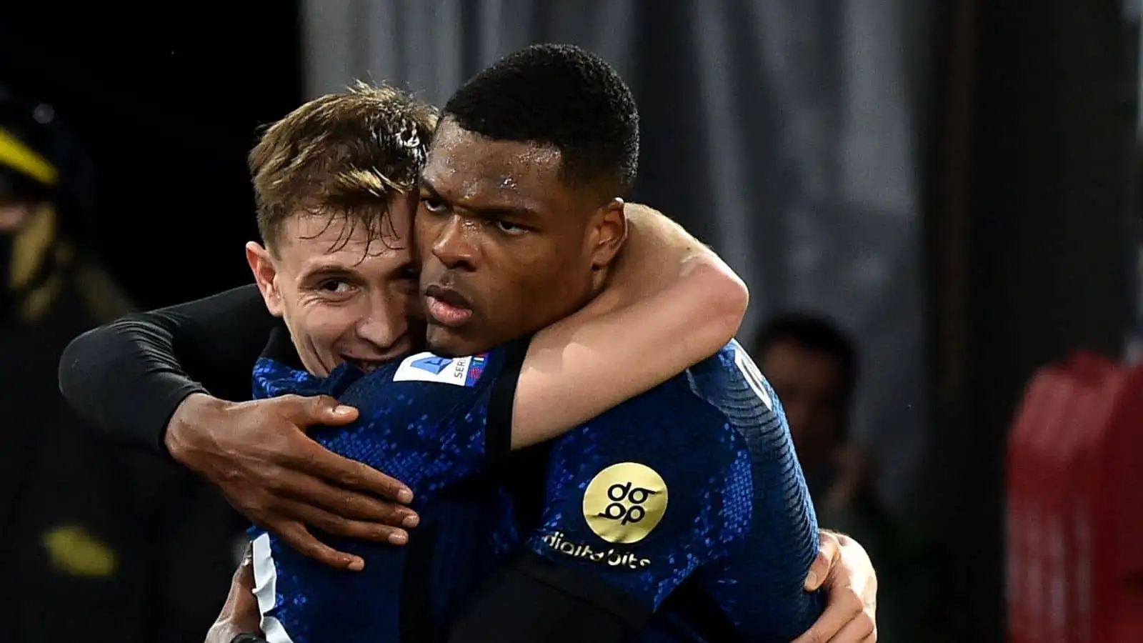 Denzel Dumfries of FC Internazionale (r) celebrates with Nicolo Barella after scoring the goal of 0-3 during the Serie A football match between AS Roma and FC Internazionale at Olimpico stadium in Rome