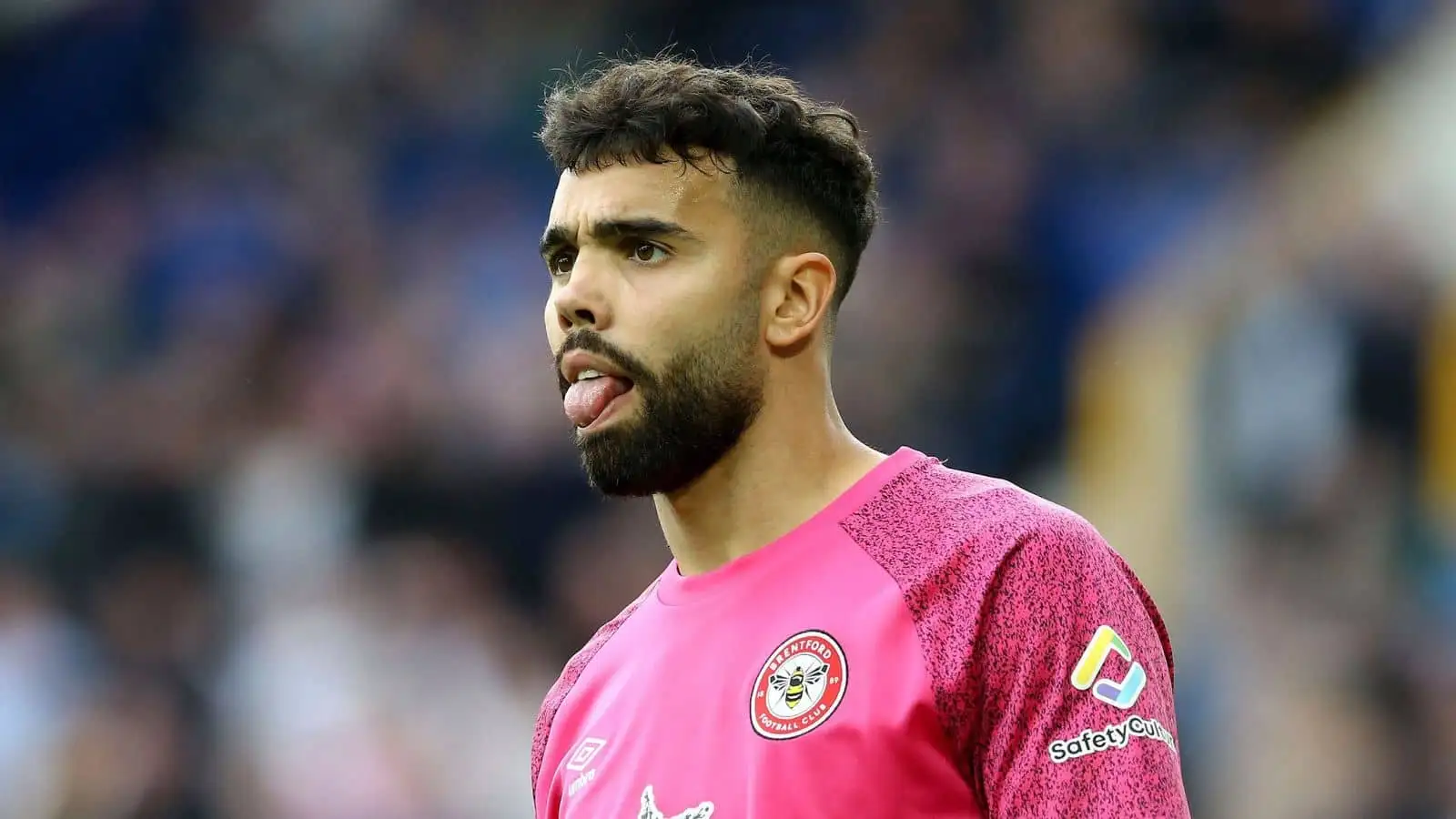 David Raya, the goalkeeper of Brentford looks on with his tongue sticking out. Premier League match, Everton v Brentford at Goodison Park in Liverpool