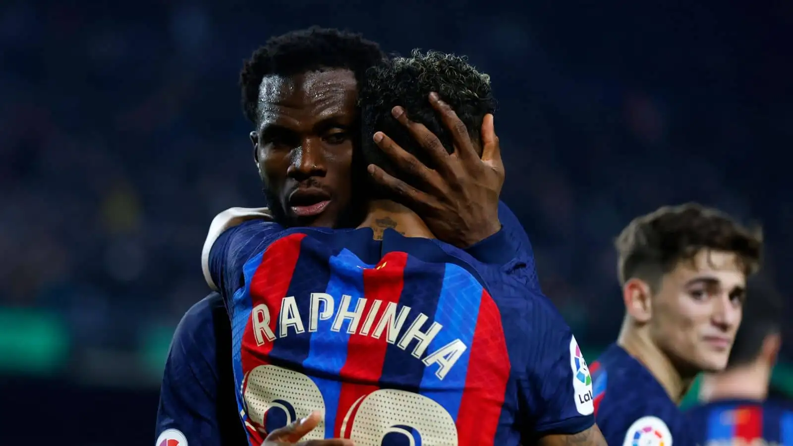 Barcelona's Raphinha, right, celebrates with Barcelona's Franck Kessie after scoring his side's third goal during a Spanish La Liga soccer match between Barcelona and Sevilla at the Camp Nou stadium in Barcelona