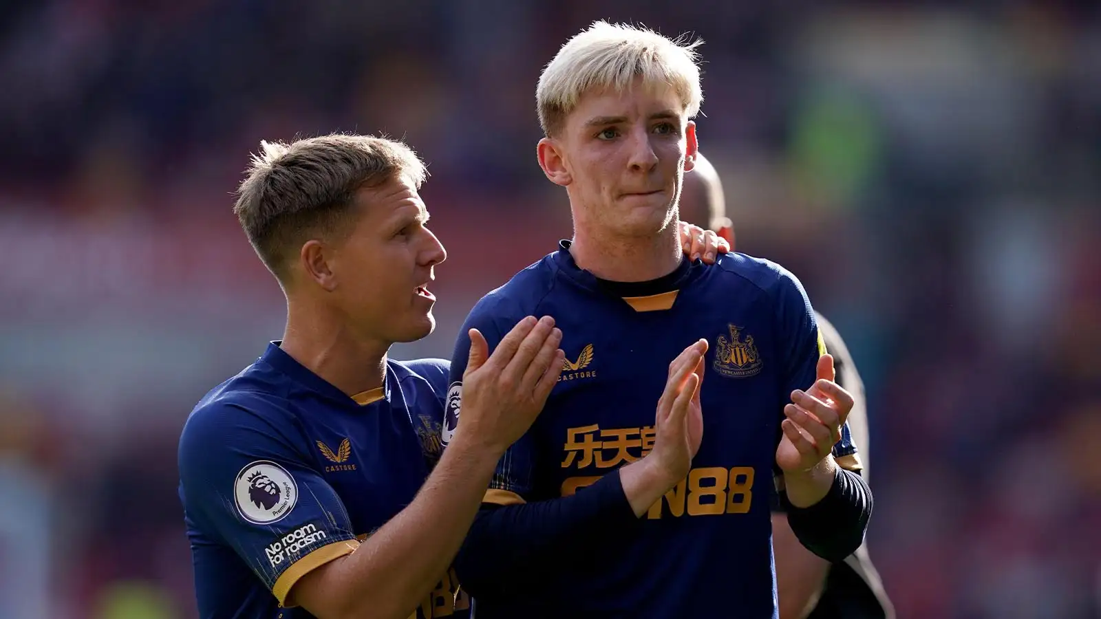 Newcastle United's Matt Ritchie speaks with team mate Anthony Gordon following the Premier League match at the Gtech Community Stadium, London. Picture date: Saturday April 8, 2023.