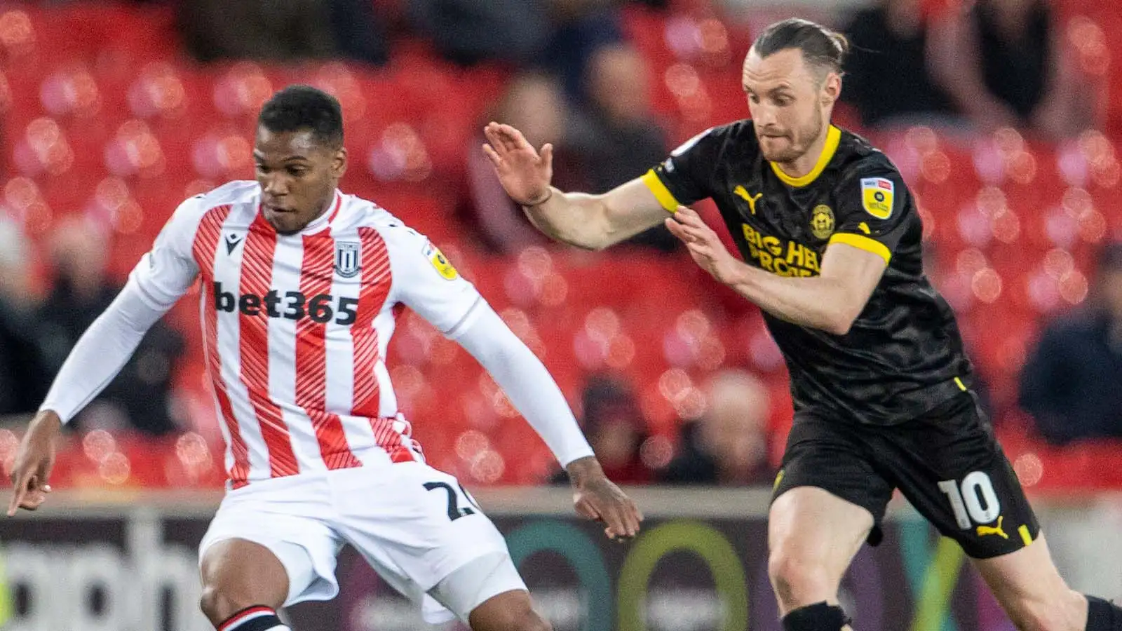 18th April 2023; Bet365 Stadium, Stoke, Staffordshire, England; EFL Championship Football, Stoke City versus Wigan Athletic; Dujon Sterling of Stoke City under pressure from Will Keane of Wigan Athletic