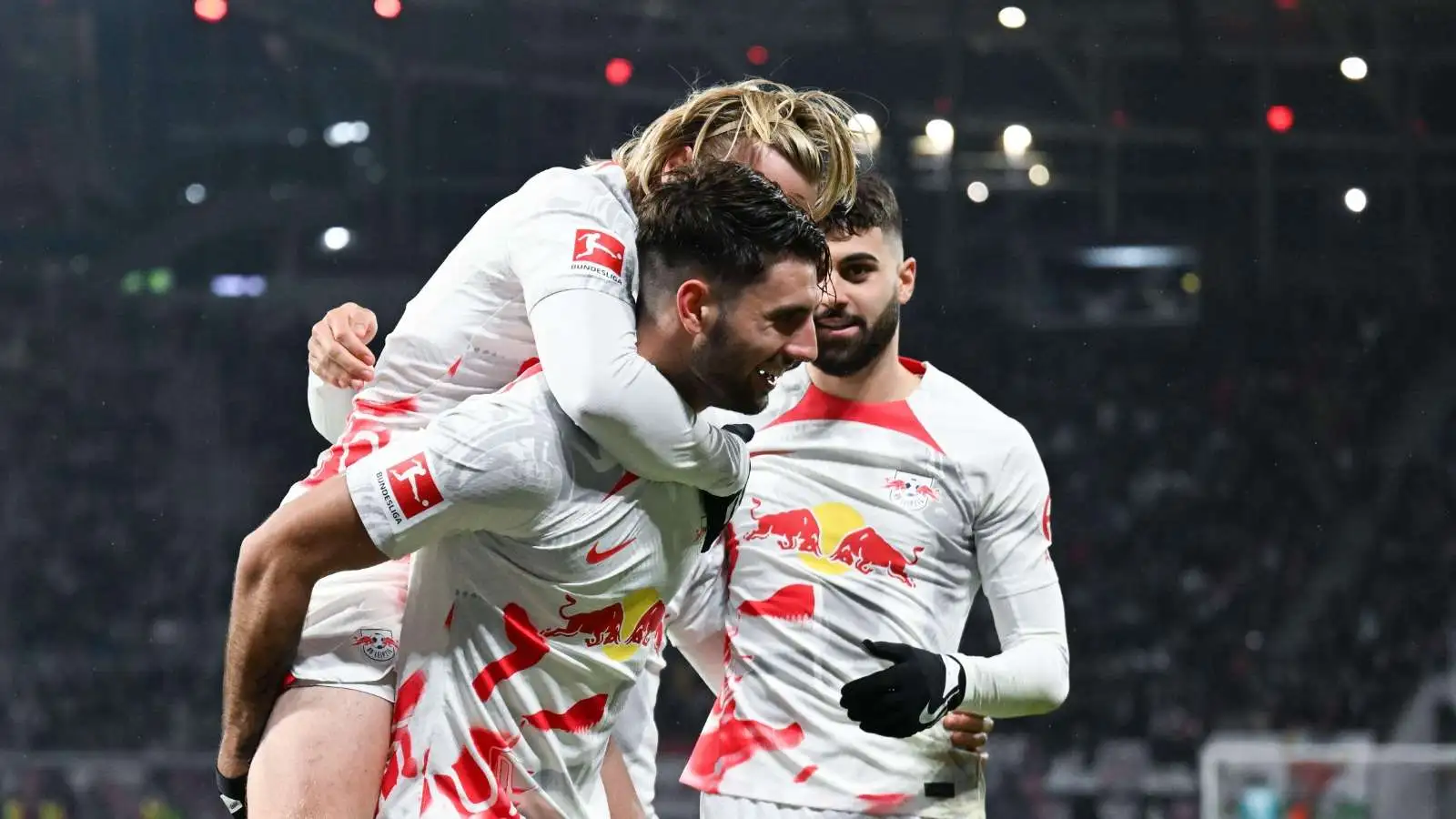 Leripzig's Dominik Szoboszlai (center) has just scored to make it 2:0 and is cheering with Emil Forsberg (l) and Josko Gvardiol