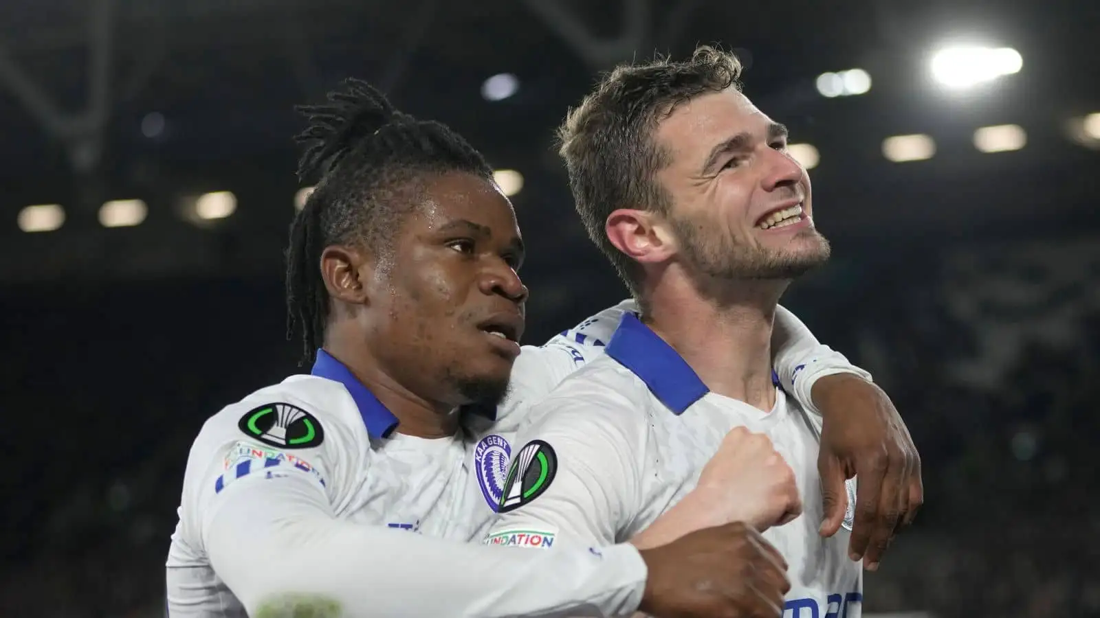 Gent's Hugo Cuyper, right, celebrates Gent's Gift Emmanuel Orban after scoring his side's opening goal during the Conference League soccer match between West Ham and Gent at the London stadium in London, England