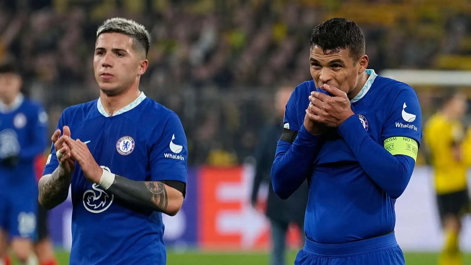Chelsea's Enzo Fernandez, left, is flanked by his teammate Thiago Silva as they cheer supporters at the end of the Champions League, round of 16, first leg soccer match between Borussia Dortmund and Chelsea FC in Dortmund, Germany, Wednesday, Feb. 15, 2023