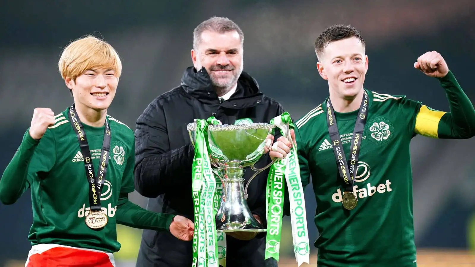 Celtic manager Ange Postecoglou (centre), Kyogo Furuhashi (left) and Callum McGregor celebrate with the trophy after winning the Premier Sports Cup Final at Hampden Park, Glasgow