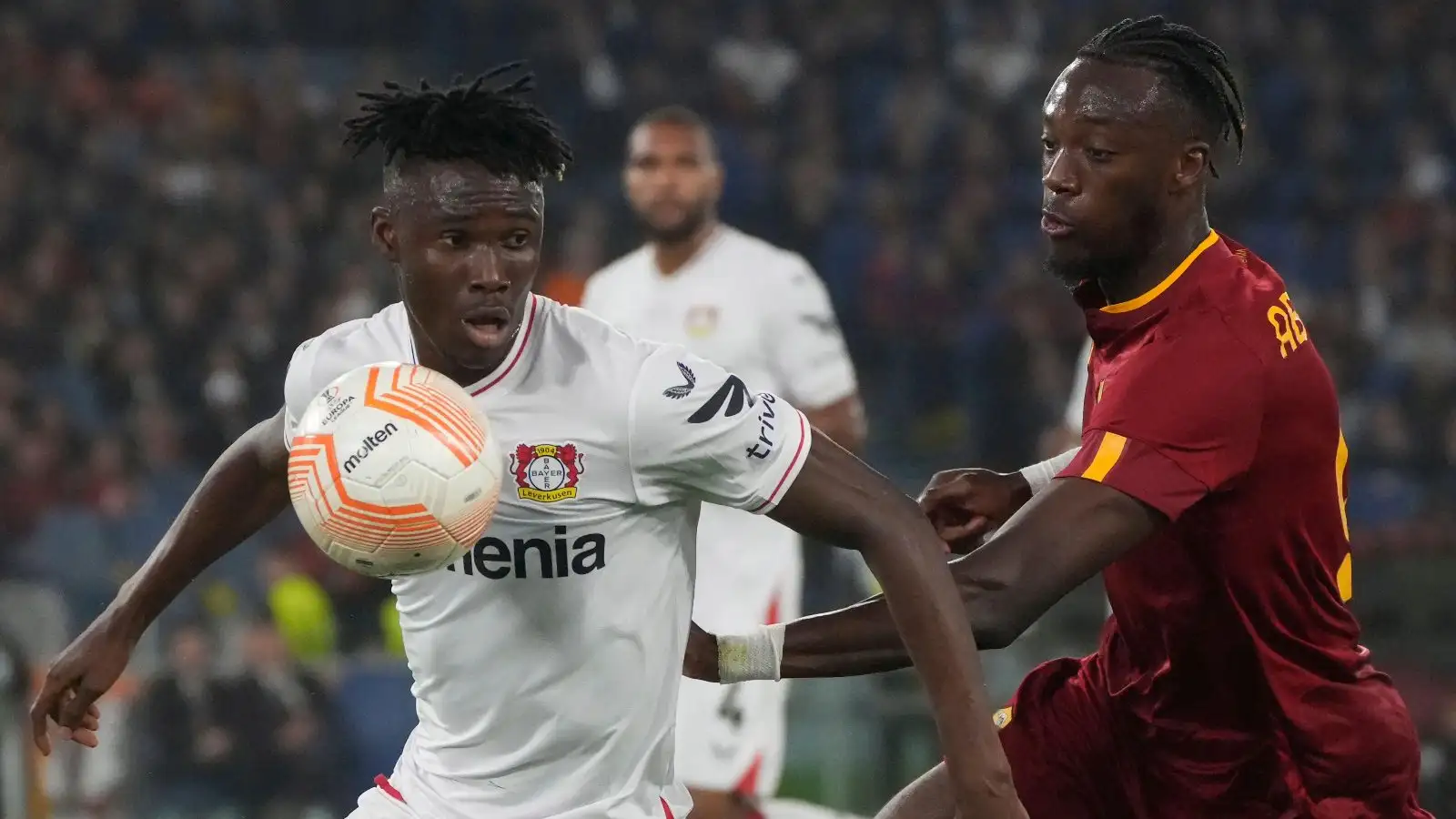 Bayer Leverkusen defender Odilon Kossounou battles with Tammy Abraham of Roma