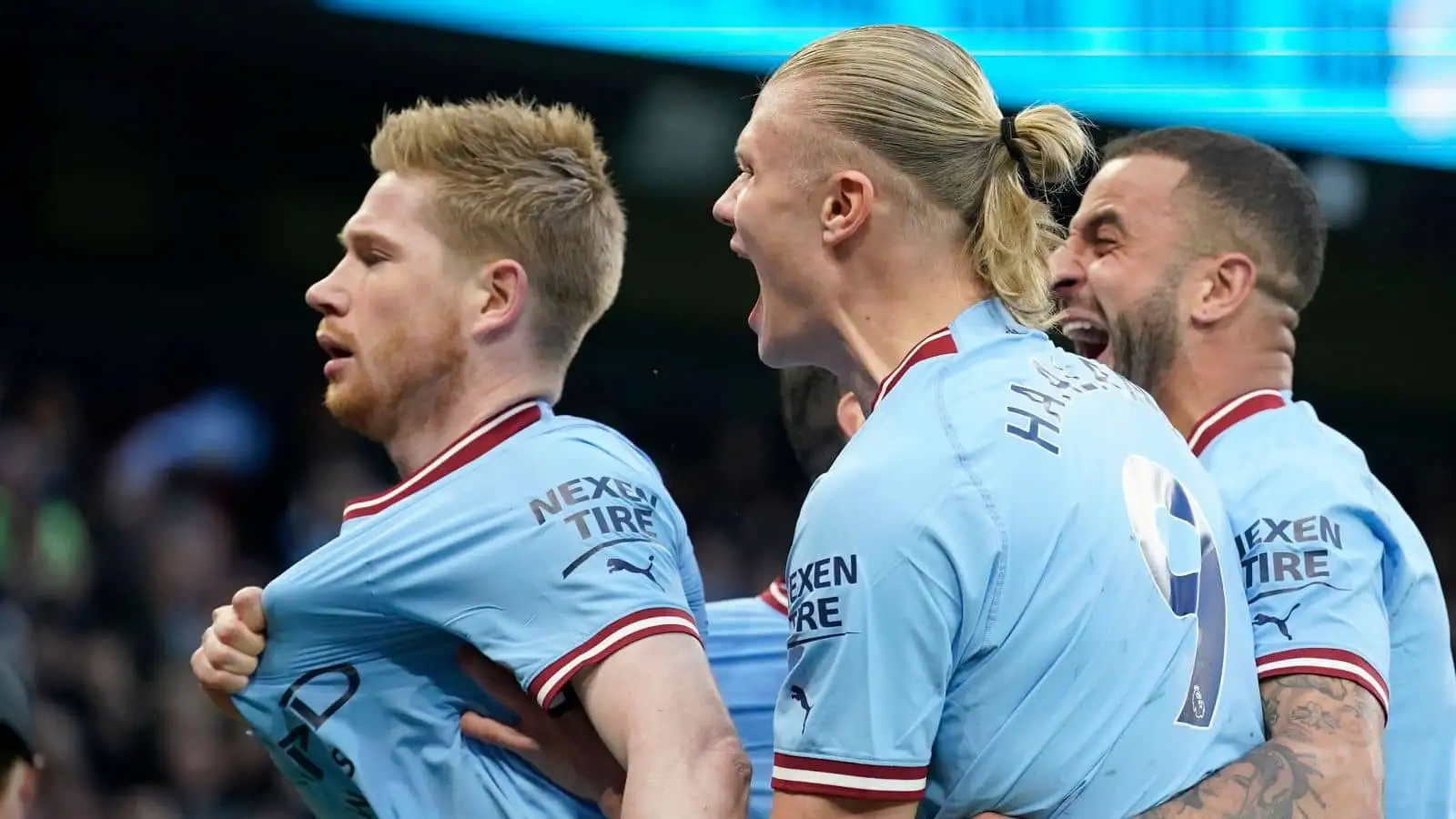 Manchester City's Kevin De Bruyne celebrates with Erling Haaland, center, and Kyle Walker, right,after scoring the opening goal during the English Premier League soccer match between Manchester City and Arsenal at Etihad stadium in Manchester