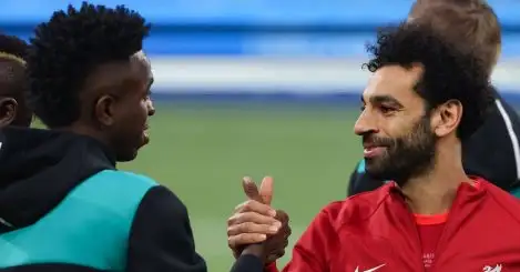 Mohamed Salah of Liverpool FC shakes hands with Vinicius Junior of Real Madrid during the line up prior to the UEFA Champions League match at Stade de France
