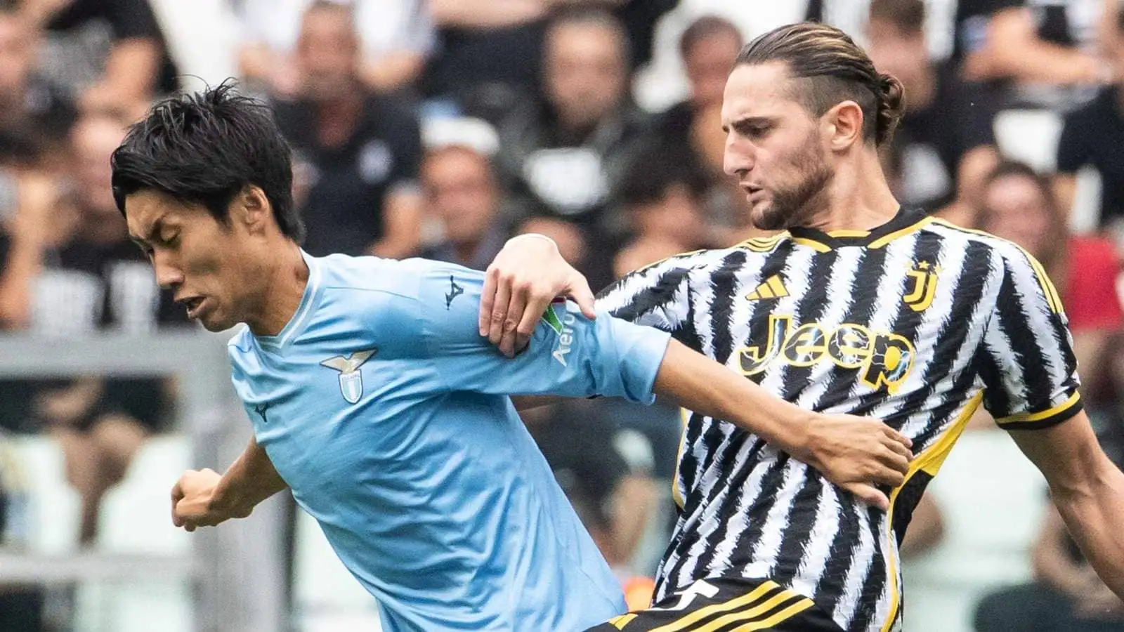 Juventus midfielder Adrien Rabiot challenging Lazio's Daichi Kamada
